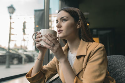 Young woman drinking coffee cup