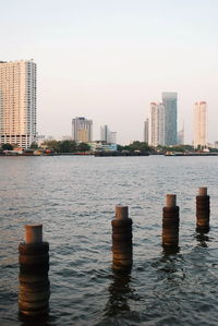 Scenic view of river and buildings against clear sky