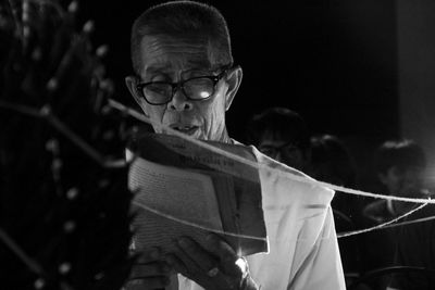 Portrait of man holding paper outdoors