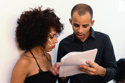 Actor and actress getting ready in the dressing room to take the stage at the theater. 