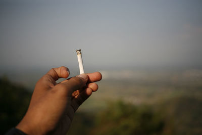 Person hand holding cigarette