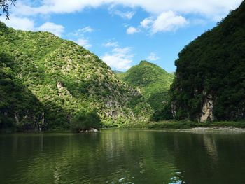 Scenic view of lake against cloudy sky