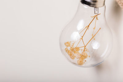 Close-up of glass jar on white background