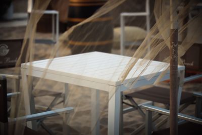 Close-up of empty chairs and table in cafe