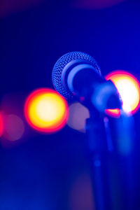 Close-up of illuminated light against clear blue sky