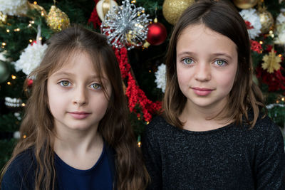 Portrait of smiling girl against christmas decoration