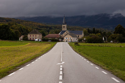 Road amidst church against sky