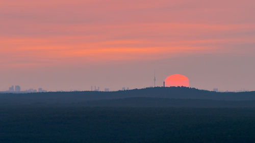Scenic view of silhouette landscape against romantic sky at sunset
