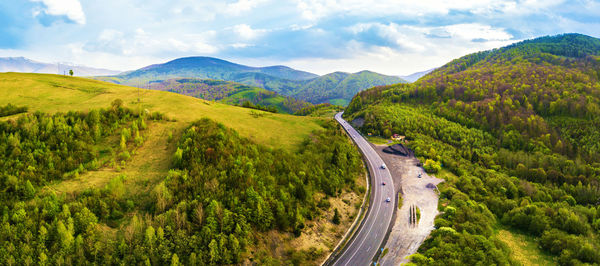 Scenic view of road amidst mountains against sky