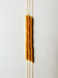 Directly above shot of matchsticks on white wall