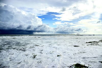 Scenic view of sea against cloudy sky