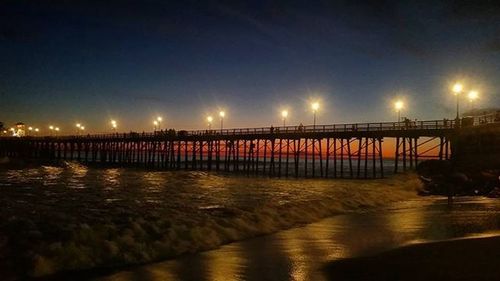 Pier on sea at night