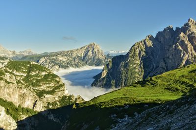 Scenic view of mountains against clear blue sky