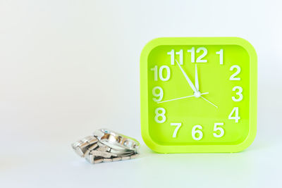 Close-up of clock over white background