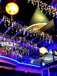 Low angle view of illuminated christmas lights at amusement park