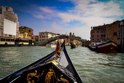 Boats in canal along buildings