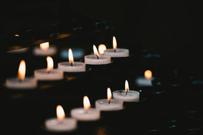 Close-up of burning candles in temple