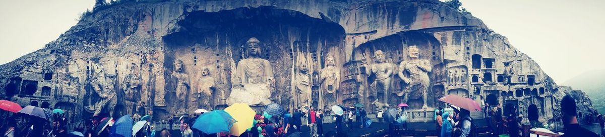 Low angle view of people on cave