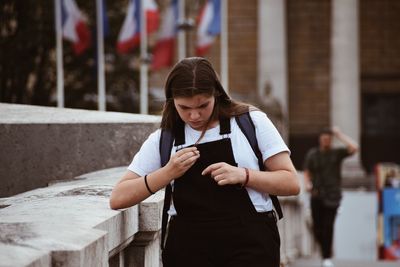 Young man using mobile phone outdoors