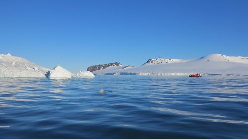 Scenic view of sea against clear blue sky