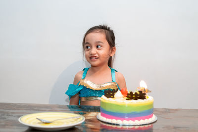 Little girl celebrating her birthday at home during quarantine. wearing arabian princess costume.