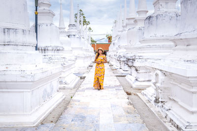 Rear view of woman standing against building