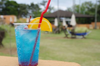 Close-up of drink against blue water