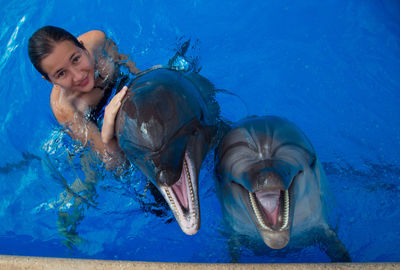 Portrait of smiling young man swimming in pool