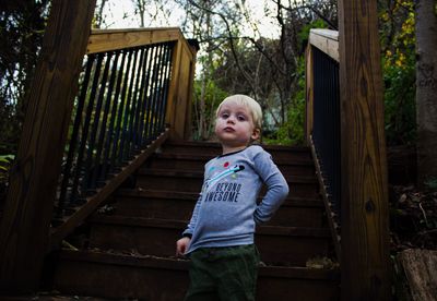 Low angle portrait of boy standing on steps