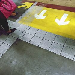 Low section of woman sitting on tiled floor