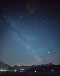 Scenic view of mountains against sky at night