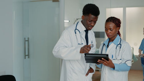 Doctors looking at digital tablet