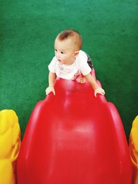 High angle view of cute baby boy on slide 