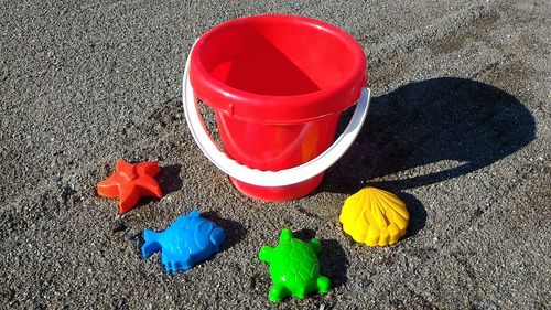 High angle view of red umbrella on sand