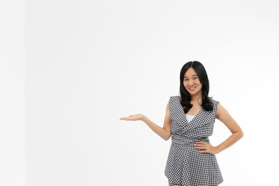 Portrait of a smiling young woman against white background