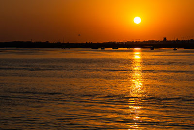 Scenic view of sea against romantic sky at sunset