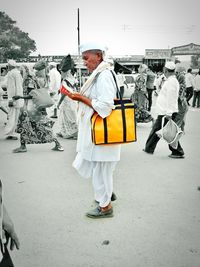 Man with umbrella against sky