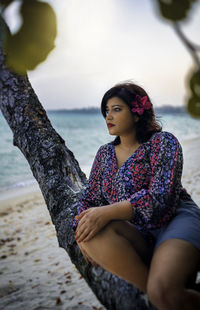 Young woman looking at sea shore