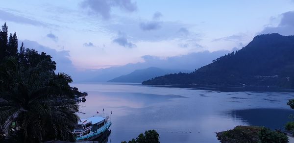 Scenic view of sea and mountains against sky