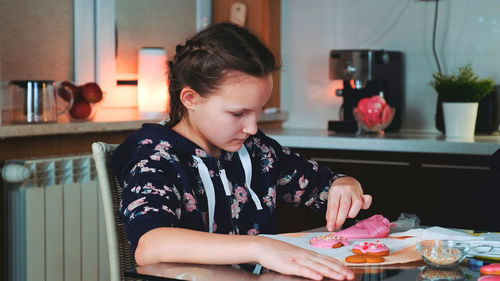 Girl playing with food at home