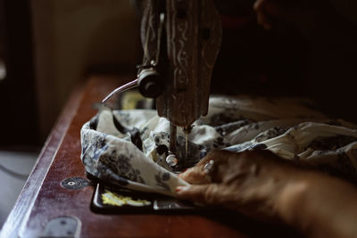 Woman hands working on a old sewing machine