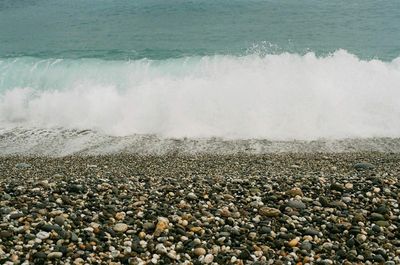 Waves splashing on rocks at beach