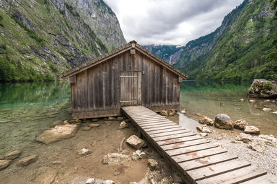 Scenic view of lake by mountains against sky