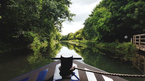 Cropped image of boat on river amidst trees