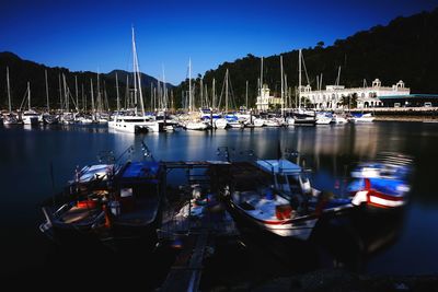 Boats moored in harbor at night