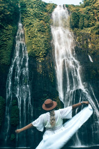 Woman in a waterfall