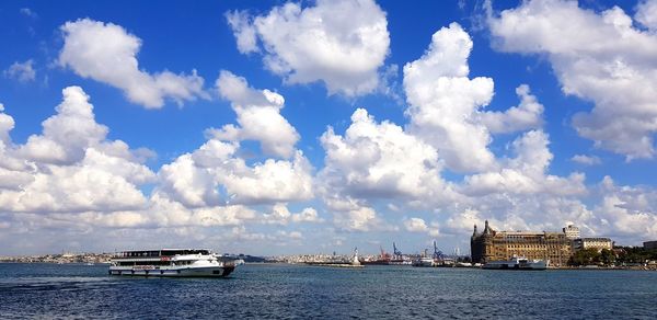 Ship in sea against cloudy sky