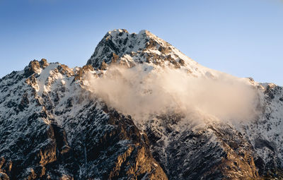 Scenic view of snowcapped mountains against clear sky