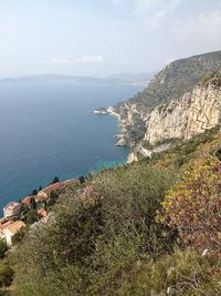 High angle view of sea and mountains against sky