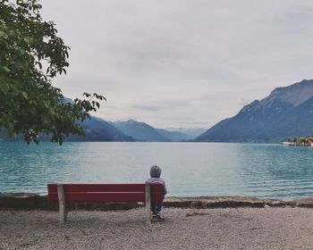People relaxing on lakeshore